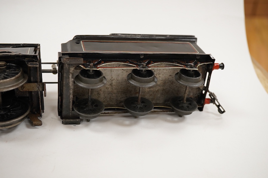 An 0 gauge Bing for Bassett-Lowke tinplate clockwork LNWR 4-4-0 tender locomotive, George the Fifth 2663, in red lined black livery with original clockwork mechanism